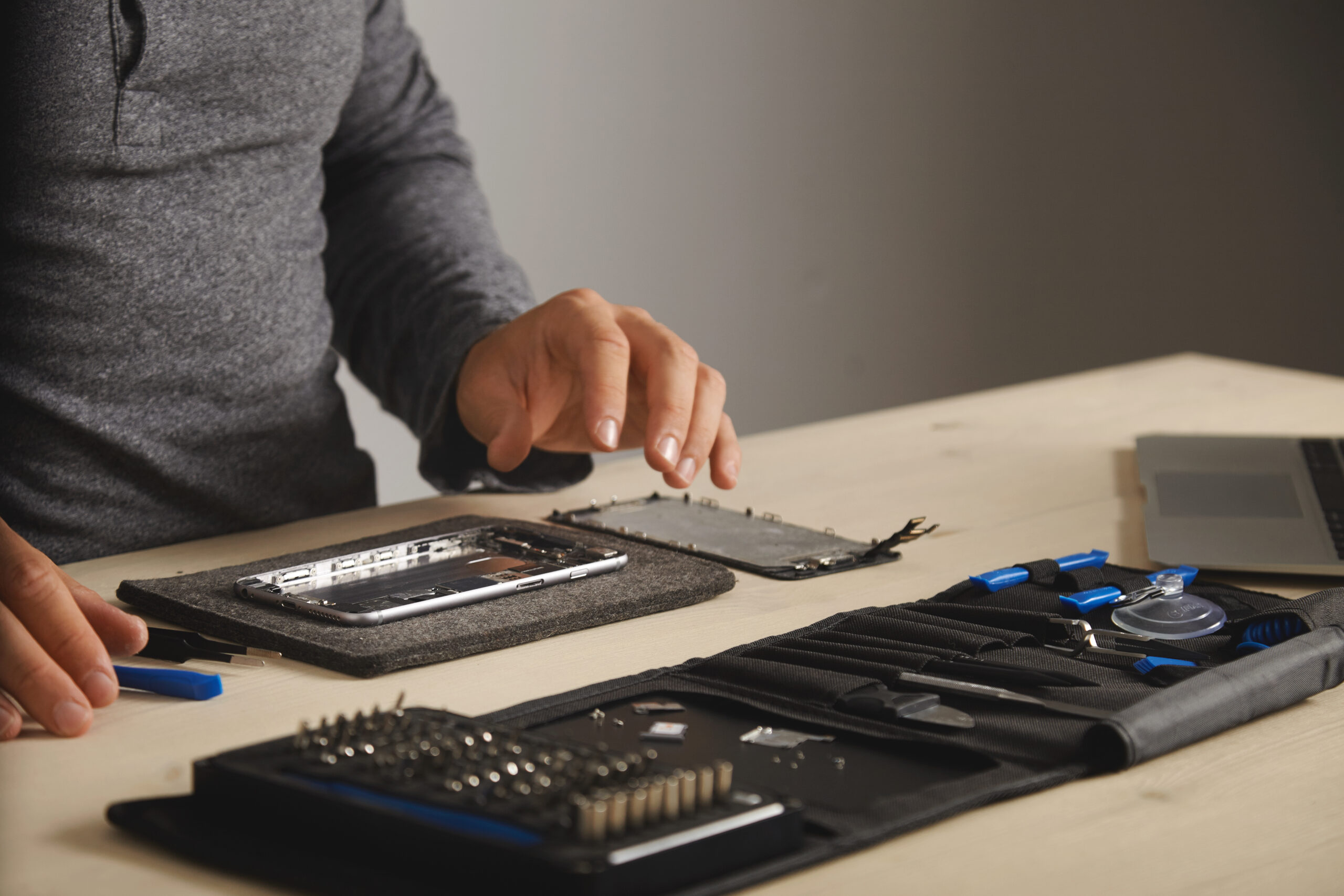 Master is ready to assemble phone and fix it with replacing new battery and screen, side view